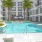 a spacious pool with tropical landscaping