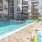 a pool with lounge chairs and umbrellas by it