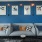 couches with a blue wall with pictures on it