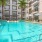 pool with reclining seats and lush landscaping