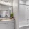 a bathroom with a tub sink and a mirror