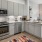 a kitchen with modern appliances and patio views connected to room