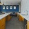 a kitchen with a blue wall and spacious counters