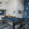 a room with a pool table, wall art and chairs